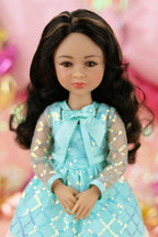 Doll in a turquoise dress with a bow, against a colorful blurred background