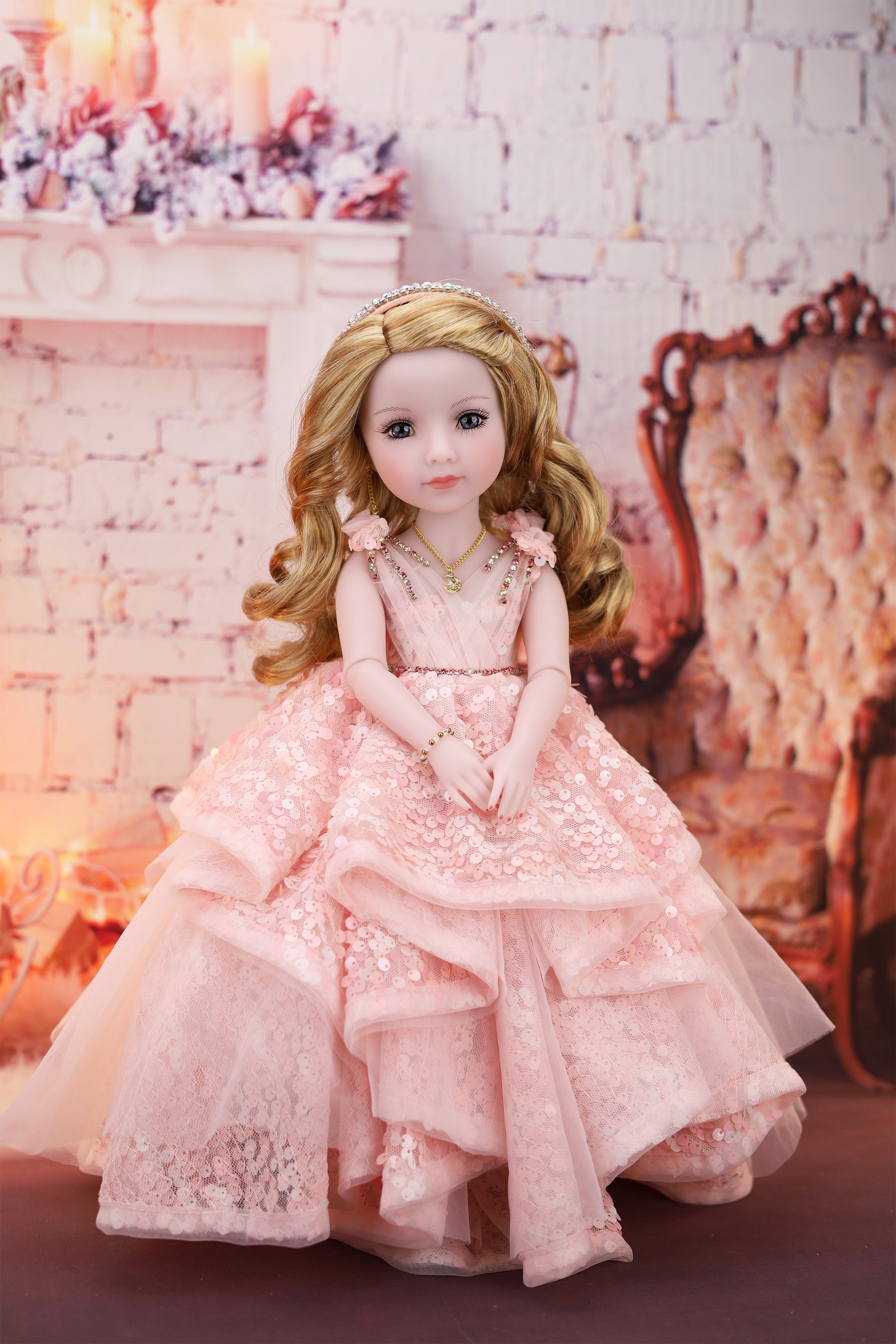 Doll in a pink dress standing in a decorative room with flowers and furniture. 