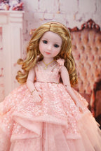 Doll in a pink dress against a decorative background