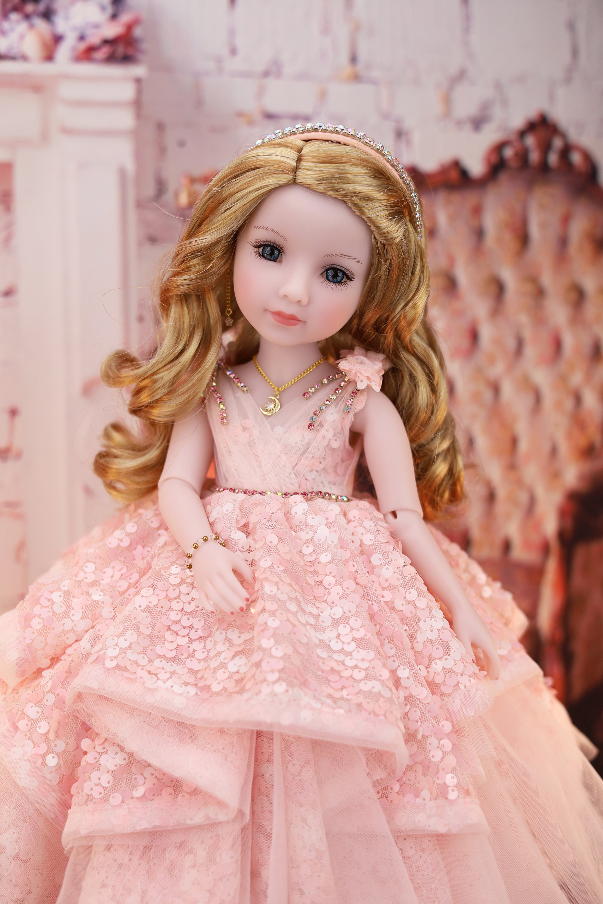 Doll in a pink dress against a decorative background