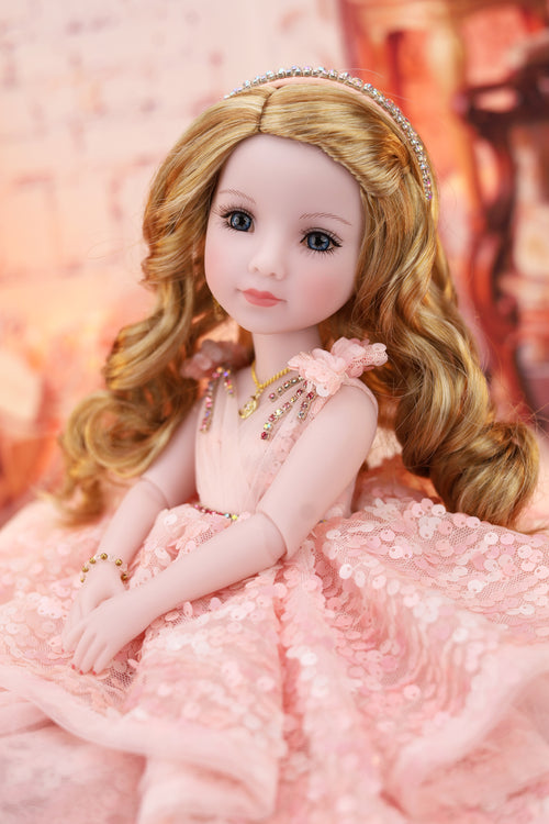 Detailed doll with blonde hair and a pink dress against a soft, blurred background