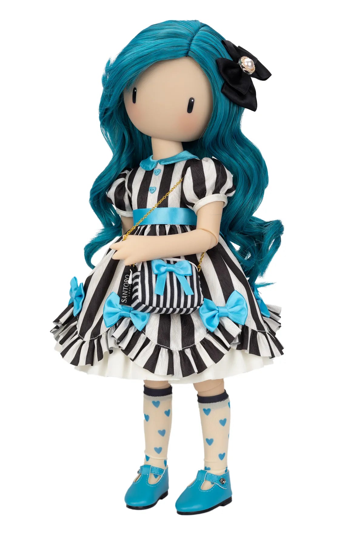 A Gorjuss doll with long bright blue hair, wearing a black-and-white vertically striped dress with blue bows and trim, cream socks with blue hearts, and blue shoes, posed against a plain white background.
