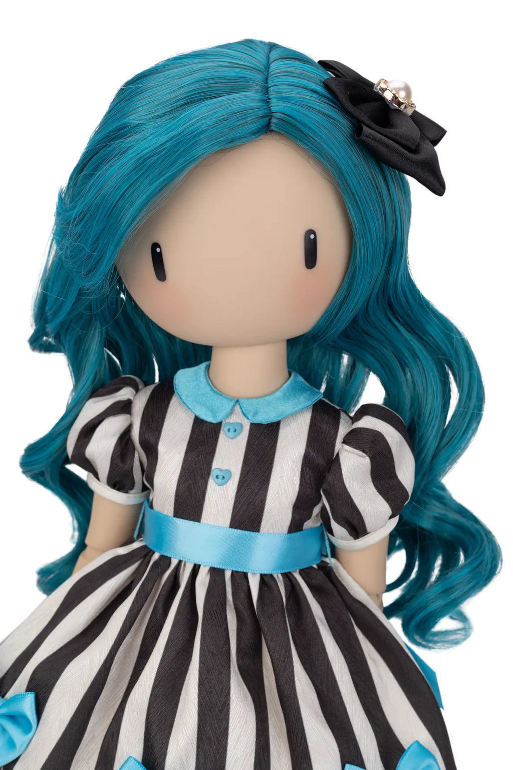 A Gorjuss doll with long turquoise-blue hair, a black bow with a pearl accent, and a black-and-white striped dress with light blue trim, shown against a plain white background.