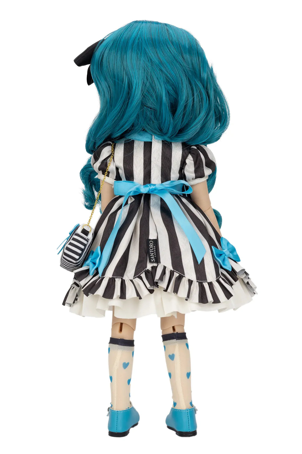 A Gorjuss doll viewed from the back wearing a black and white vertically striped dress with light blue accents, including a blue bow at the waist, blue shoes, and bright blue hair, on a plain white background.