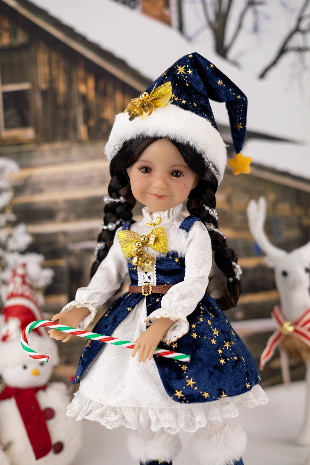 Doll in festive outfit with candy canes against a snowy background