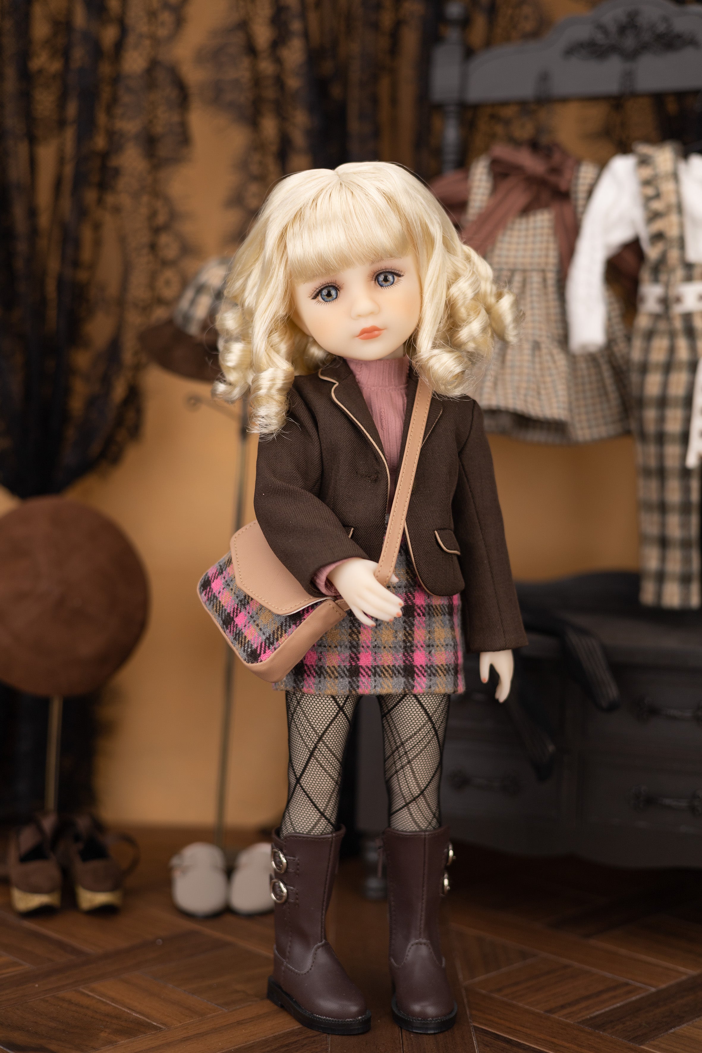 Doll with blonde hair and a plaid outfit standing in a room with clothing and bags.