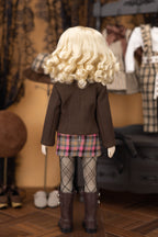 Doll wearing a brown coat, plaid skirt, and patterned tights in a store setting.