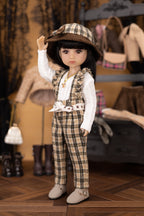 Doll in plaid outfit with hat in a vintage-style room