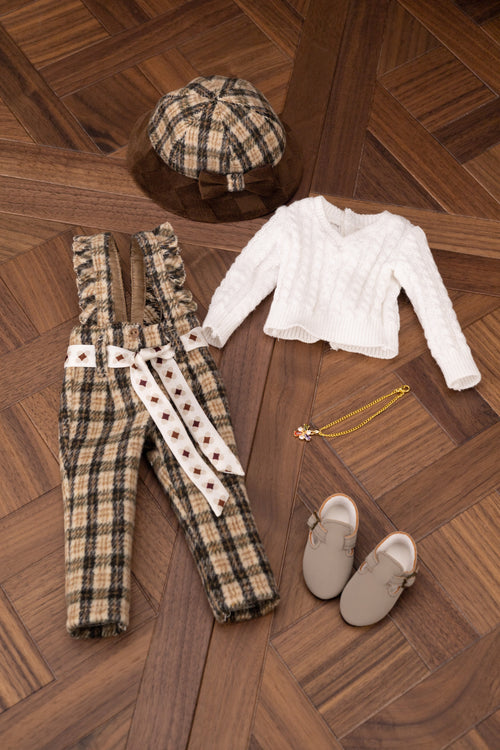 Plaid overalls, white shirt, gray shoes, and cap on a wooden floor