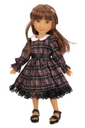 Doll wearing a plaid dress with a white collar on a white background