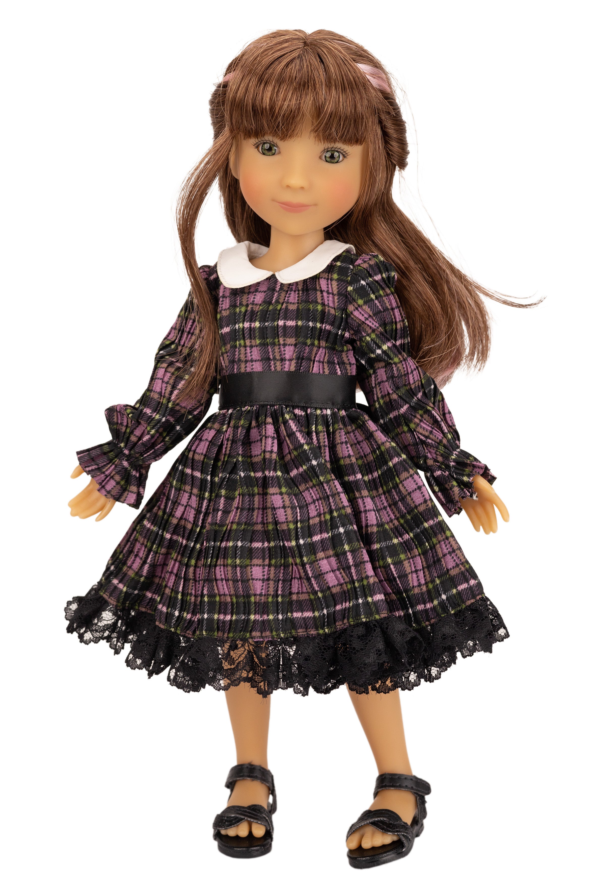 Doll wearing a plaid dress with a white collar on a white background