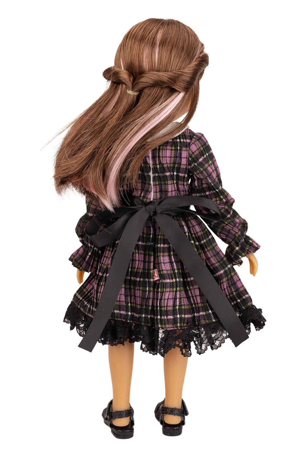 Doll wearing a plaid dress with a black ribbon on a white background