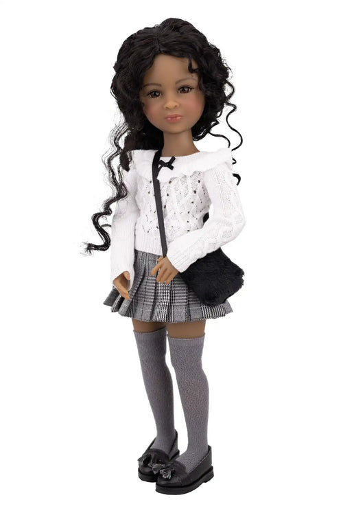 Doll wearing a white jacket, plaid skirt, and black shoes on a white background