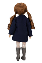 Doll wearing a navy coat, white tights, and gray boots on a white background