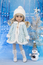Doll in winter outfit with snowman and Christmas tree in the background