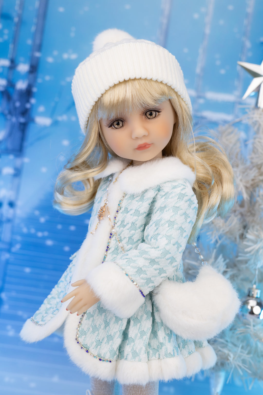 Doll in a winter outfit with a blue snowy background