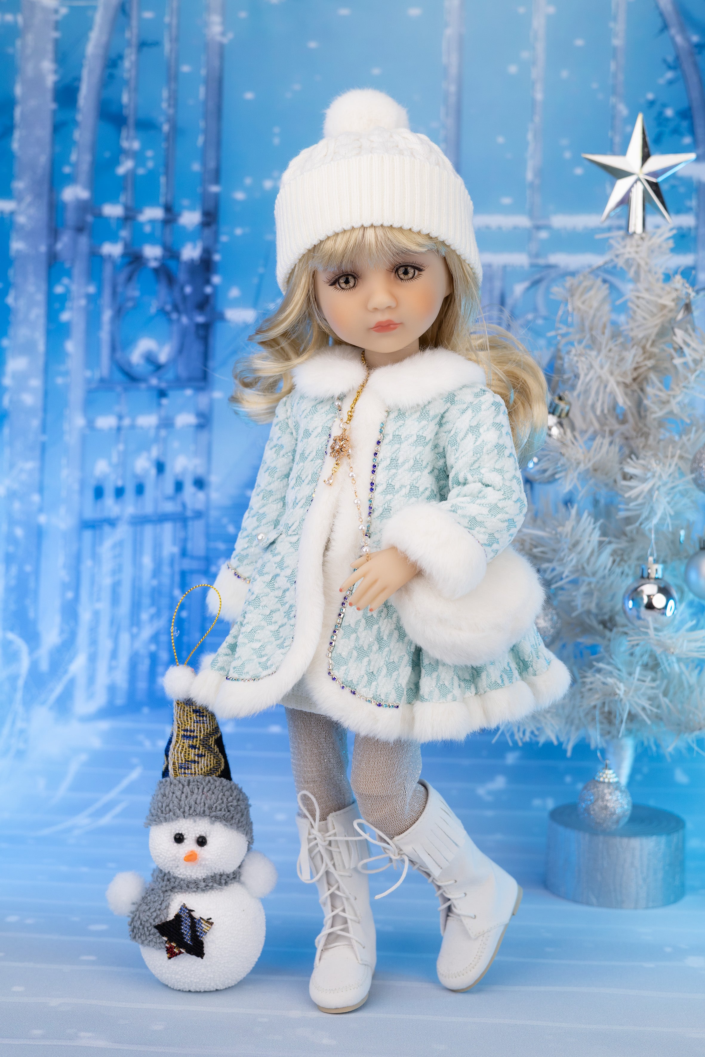Doll in winter outfit with snowman and festive background