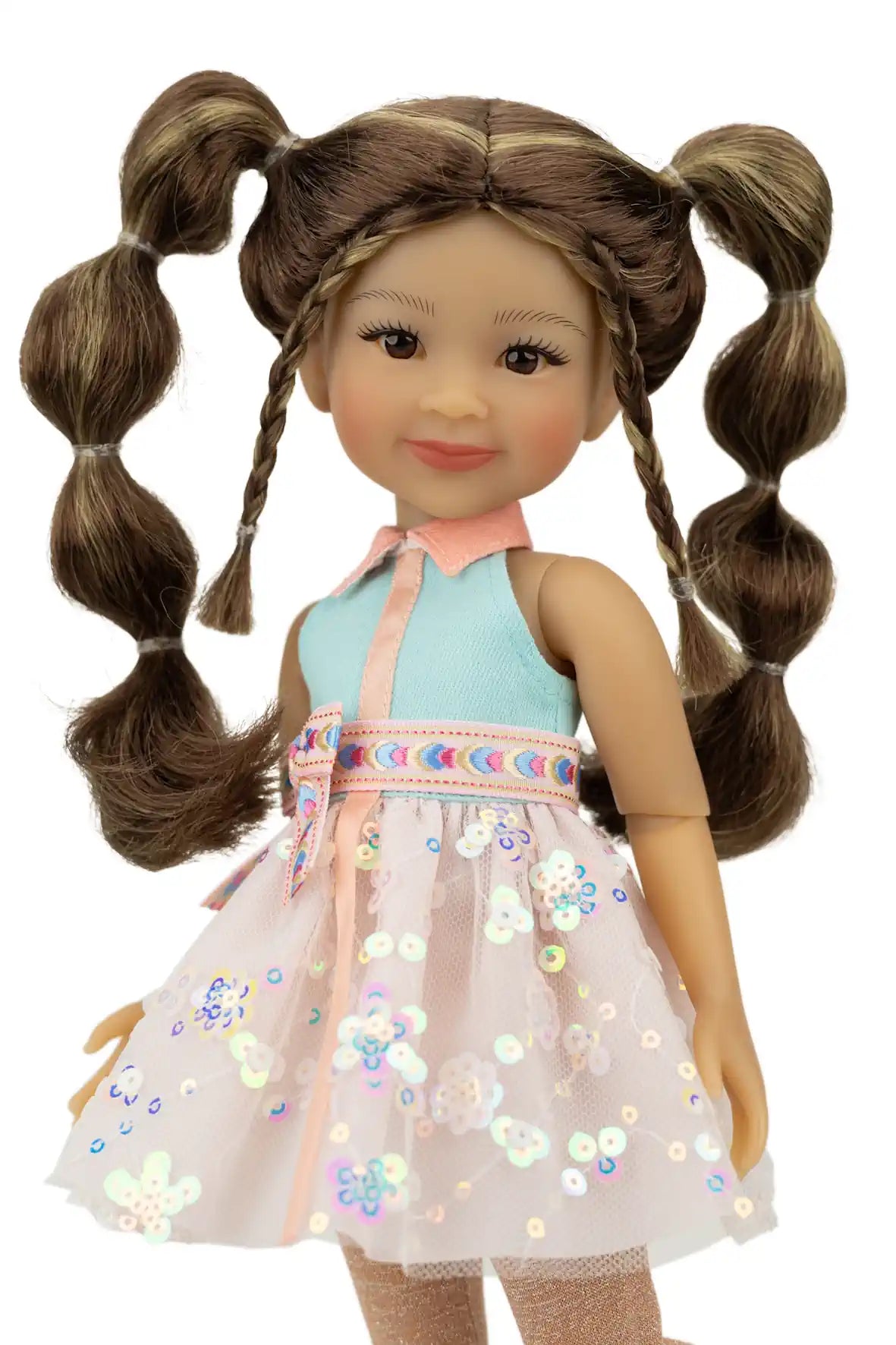 Abby with braided hair wearing a light blue top and floral dress on a white background