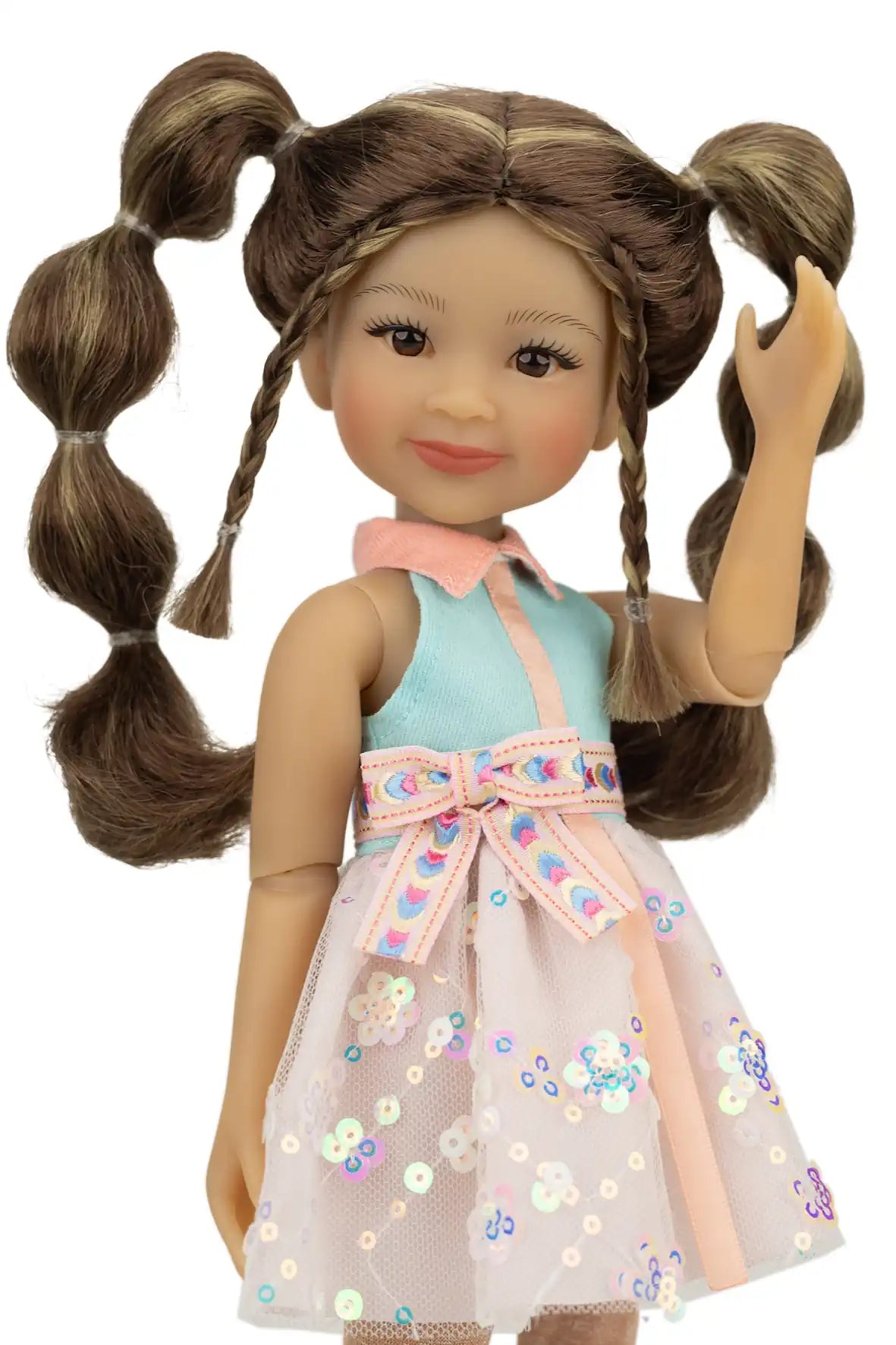 Abby with braided hair wearing a floral dress on a white background