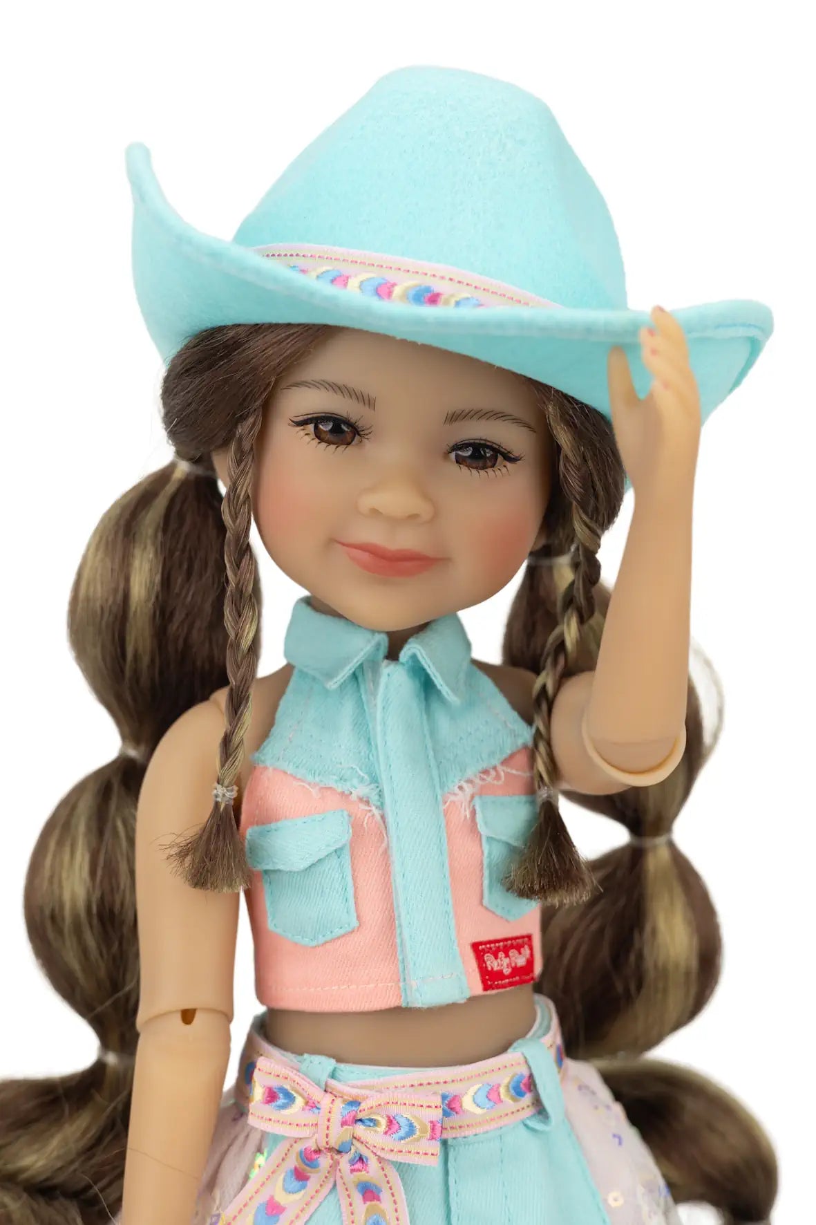 Amina wearing a turquoise cowboy hat and outfit on a white background
