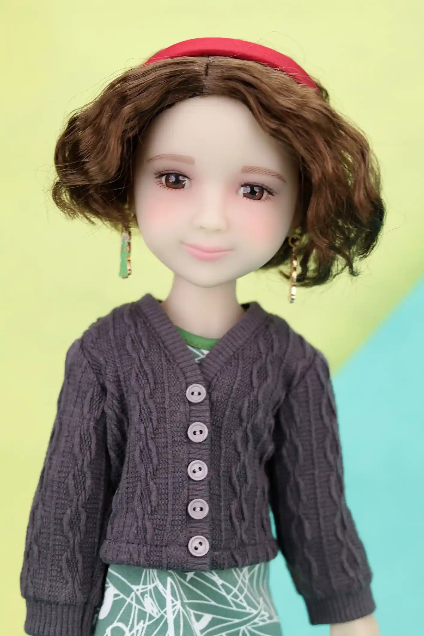 Ava wearing a purple cardigan with a colorful background