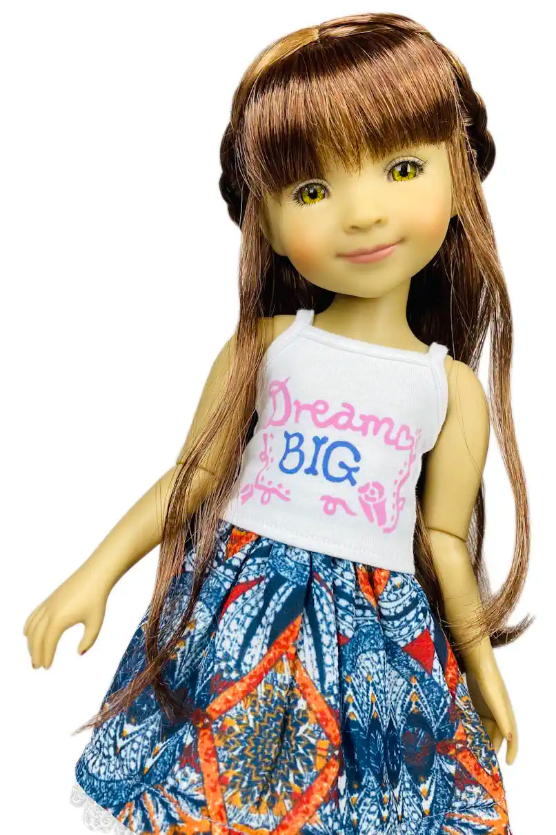 Bella wearing a white top with 'Dream Big' text and a colorful skirt on a white background