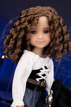 Clark with curly brown hair wearing a white blouse and black vest against a blue background