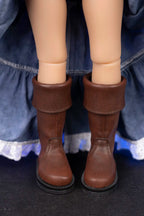 Brown boots worn by Clark with a blue skirt on a dark background