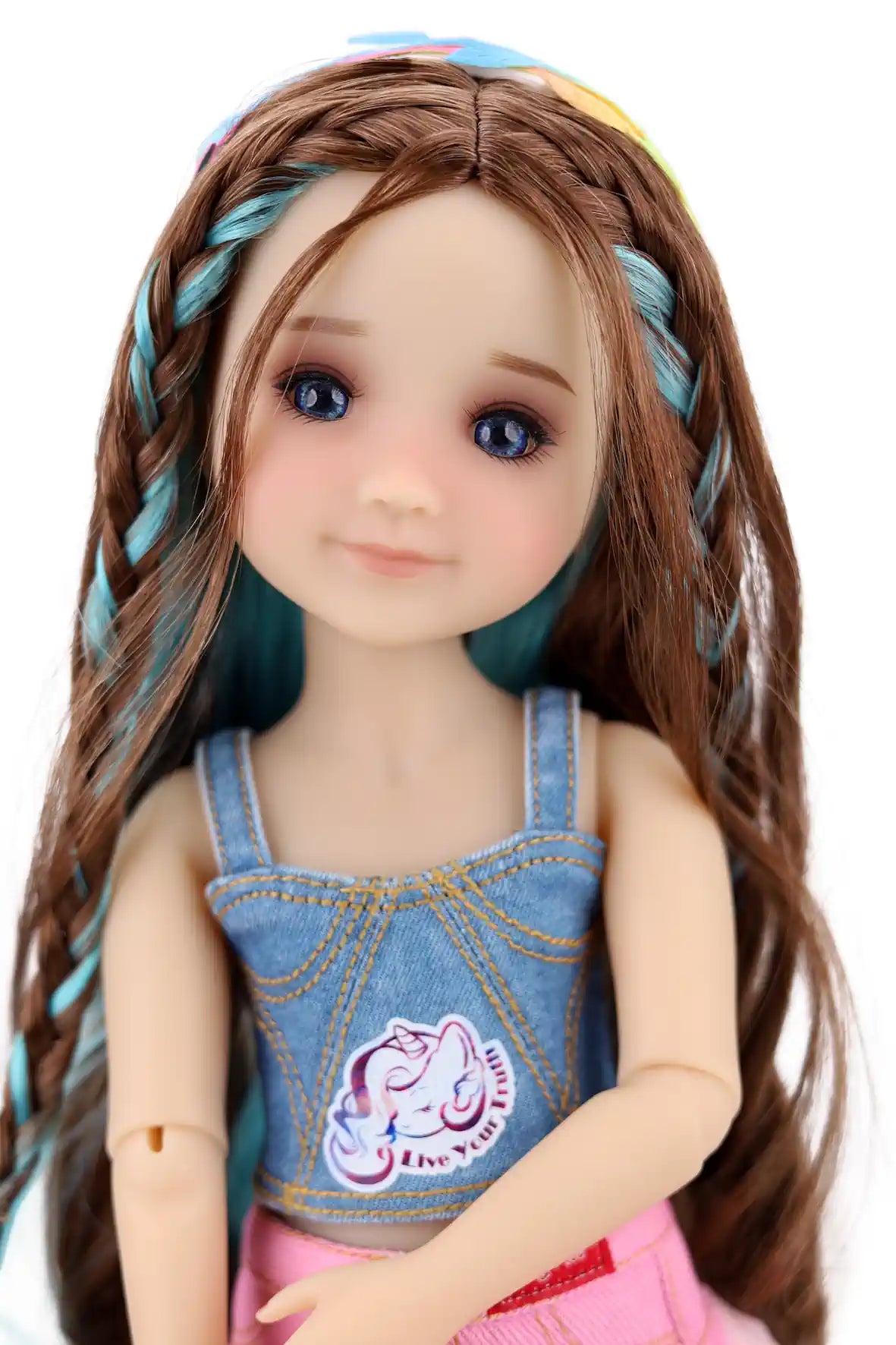 Ella with long brown hair and denim overalls on a white background