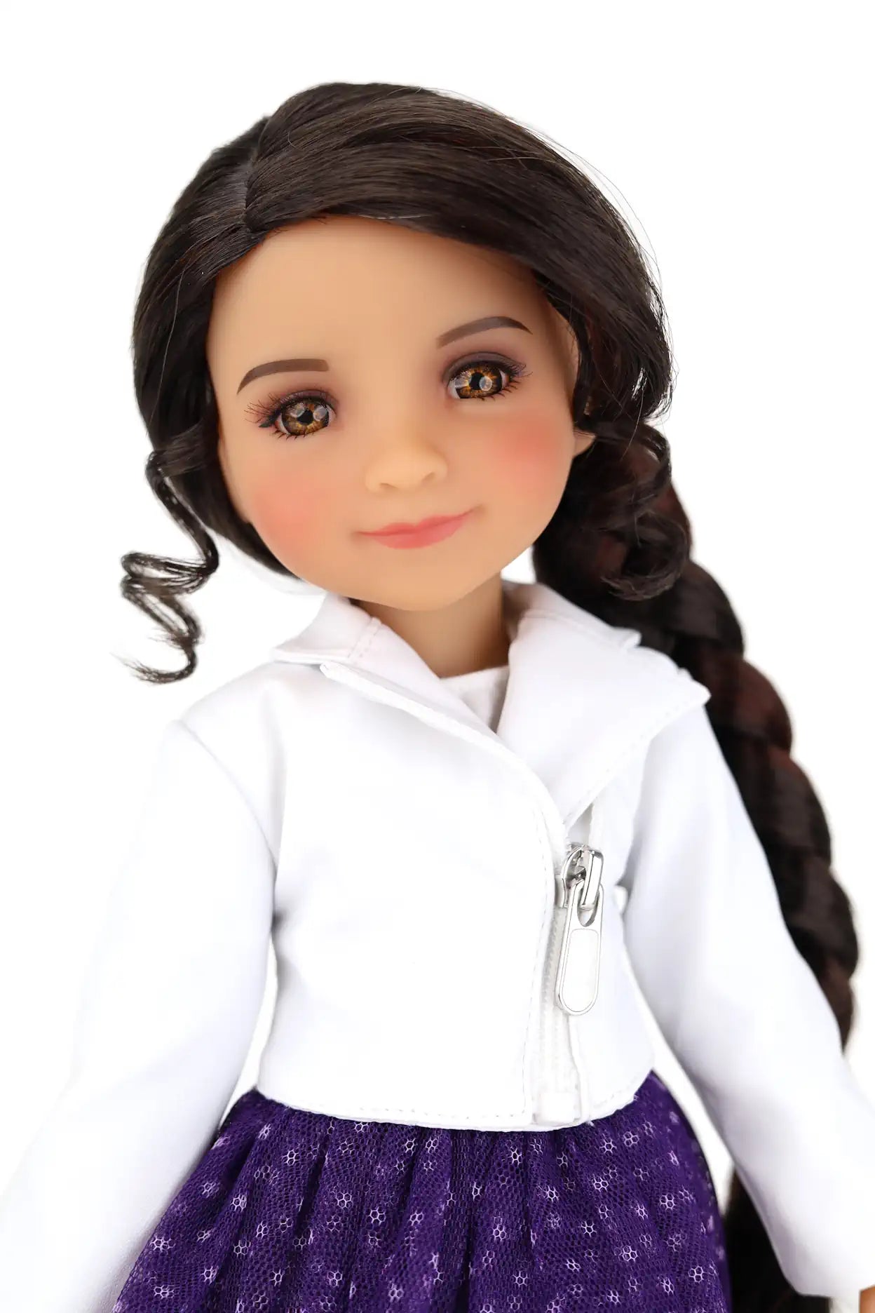 Freida with long brown hair styled in a braid, wearing a white shirt and purple skirt.