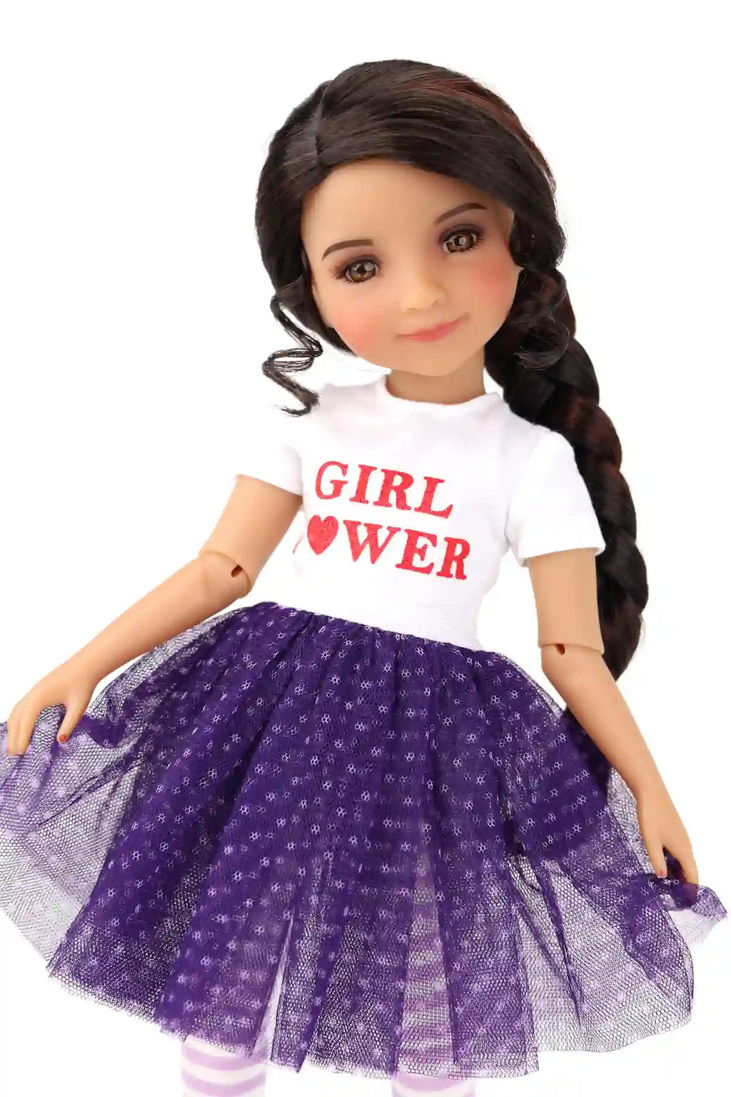 Freida wearing a white shirt and a purple polka dot skirt on a white background