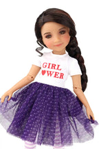 Freida wearing a white shirt and a purple polka dot skirt on a white background