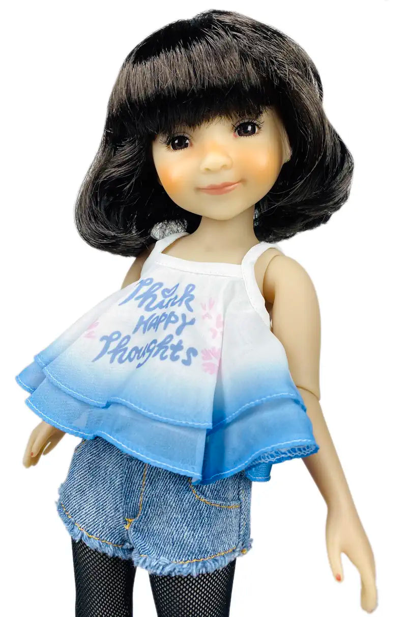 Hanna wearing a white top with blue sleeves and denim shorts on a white background