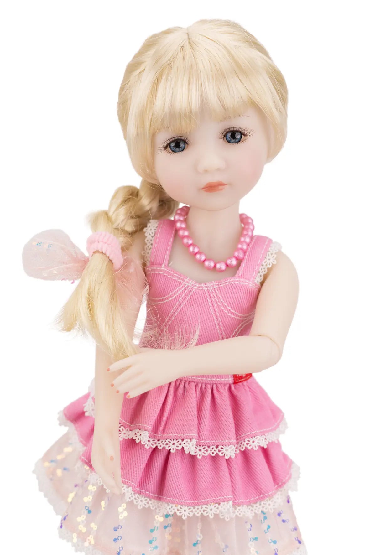 Karina with blonde hair and a pink dress on a white background