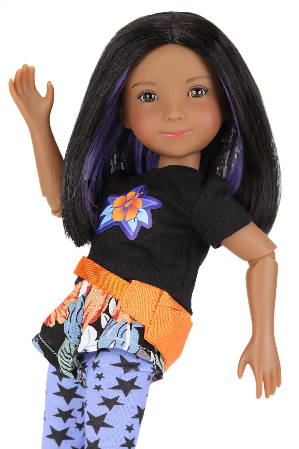 Kelsey wearing a black shirt with a colorful flower design, orange belt, and blue pants with star patterns on a white background.