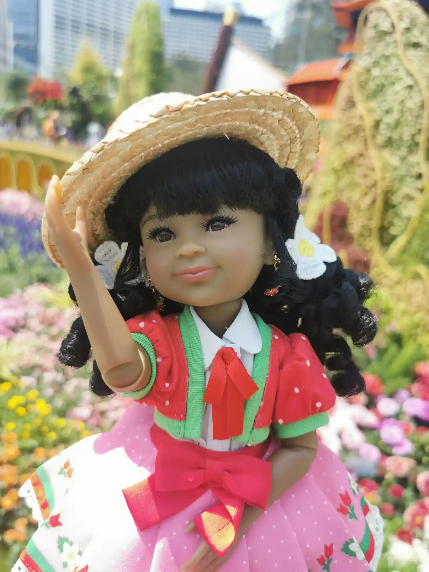 Kyra in a strawberry shortcake outfit with a straw hat in a garden setting