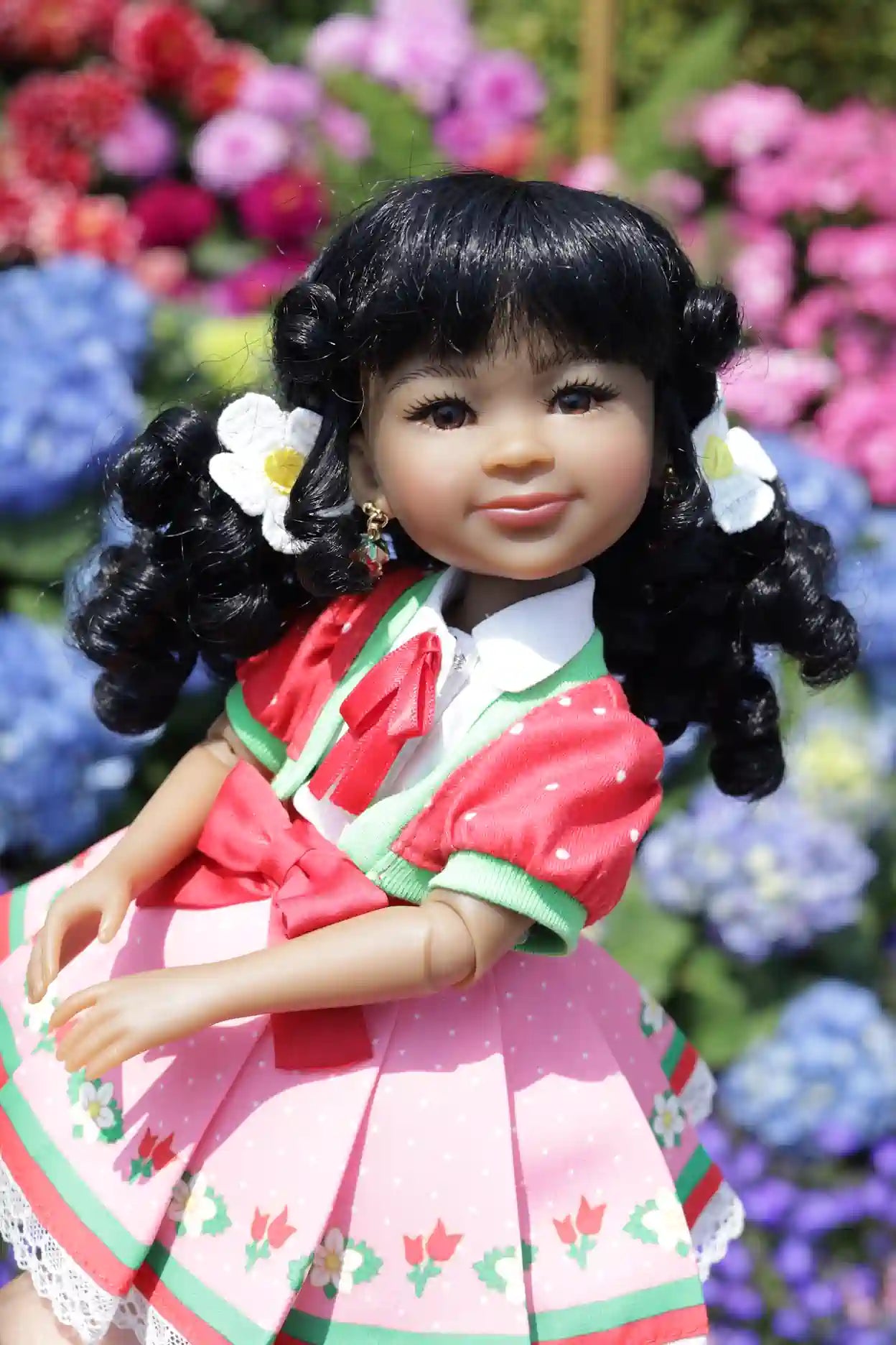 Kyra in a traditional outfit with flowers in hair against a floral background