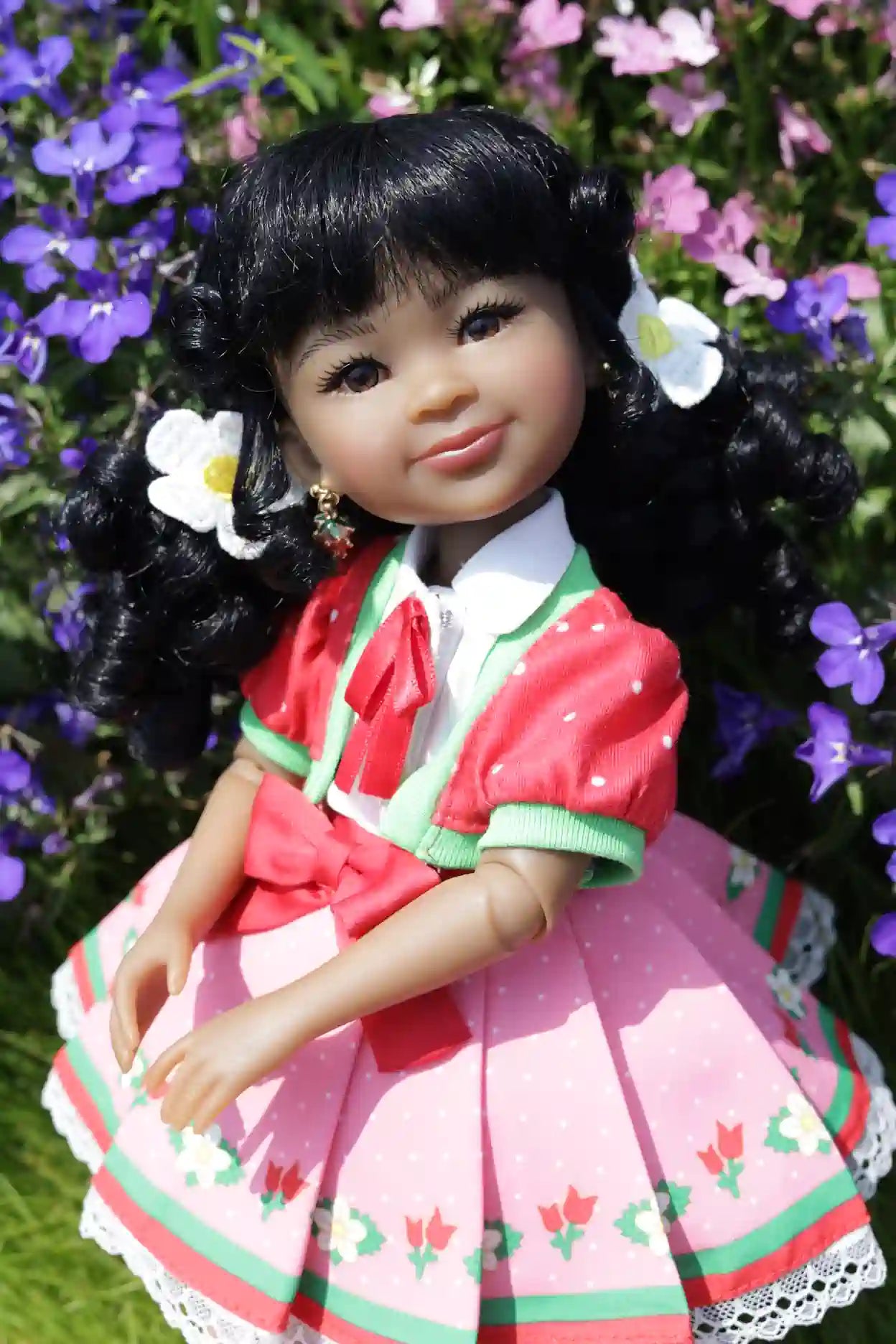 Kyra in a traditional outfit with flowers in hair against a floral background