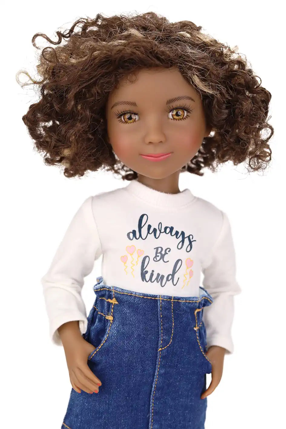 Maya wearing a white shirt with 'always be kind' text and blue overalls on a white background