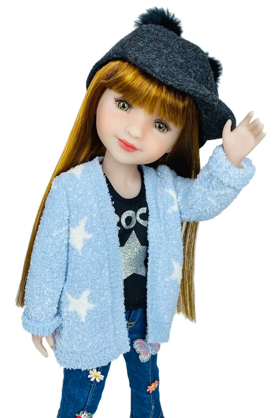 Stella wearing a blue cardigan, black beanie, and star-patterned shirt on a white background