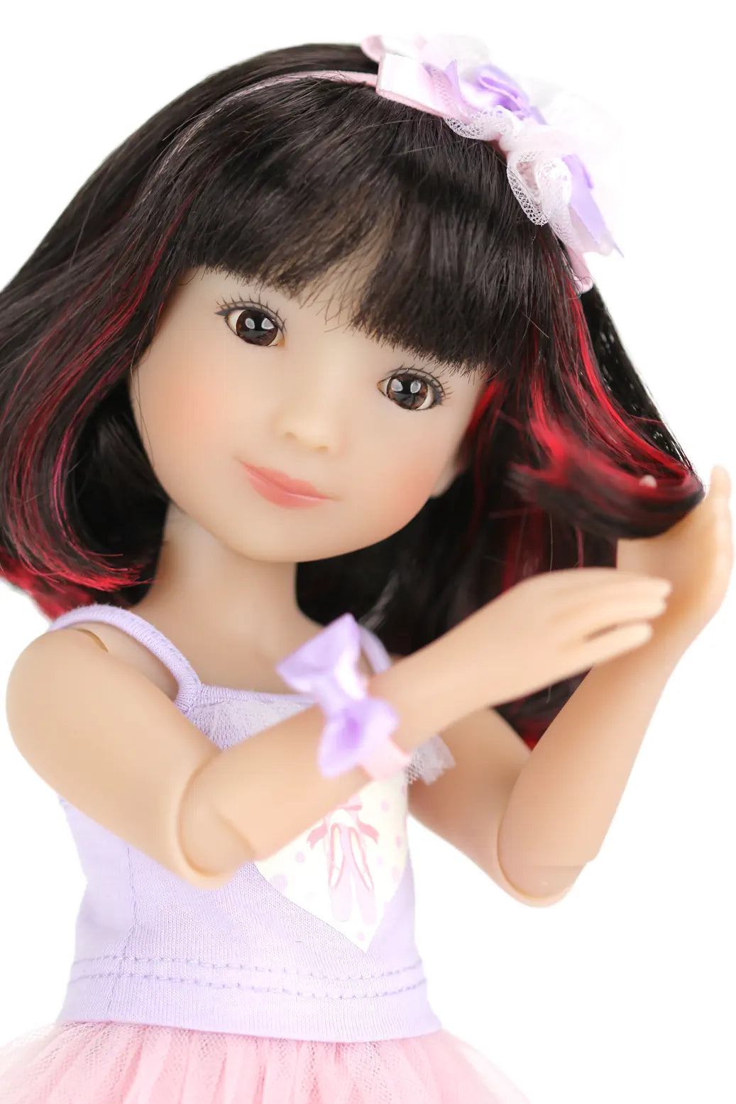 Sydney with black hair and a pink headband on a white background