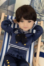 Tyler in a navy blue outfit with gold buttons on a striped chair
