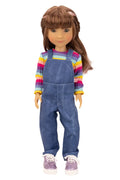 Doll wearing a colorful striped shirt and blue overalls on a white background