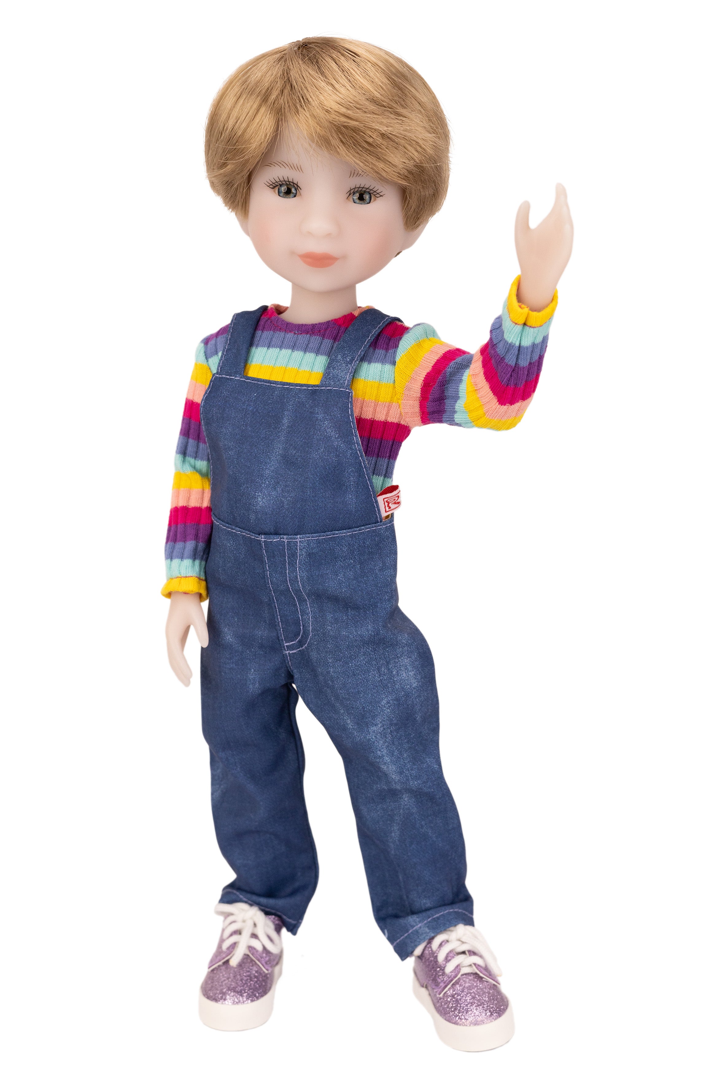 Doll wearing a colorful striped shirt and blue overalls on a white background