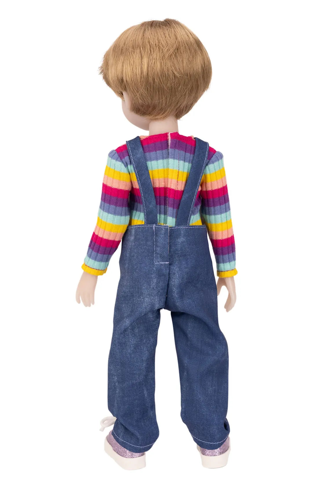 Doll wearing a colorful striped shirt and blue overalls on a white background