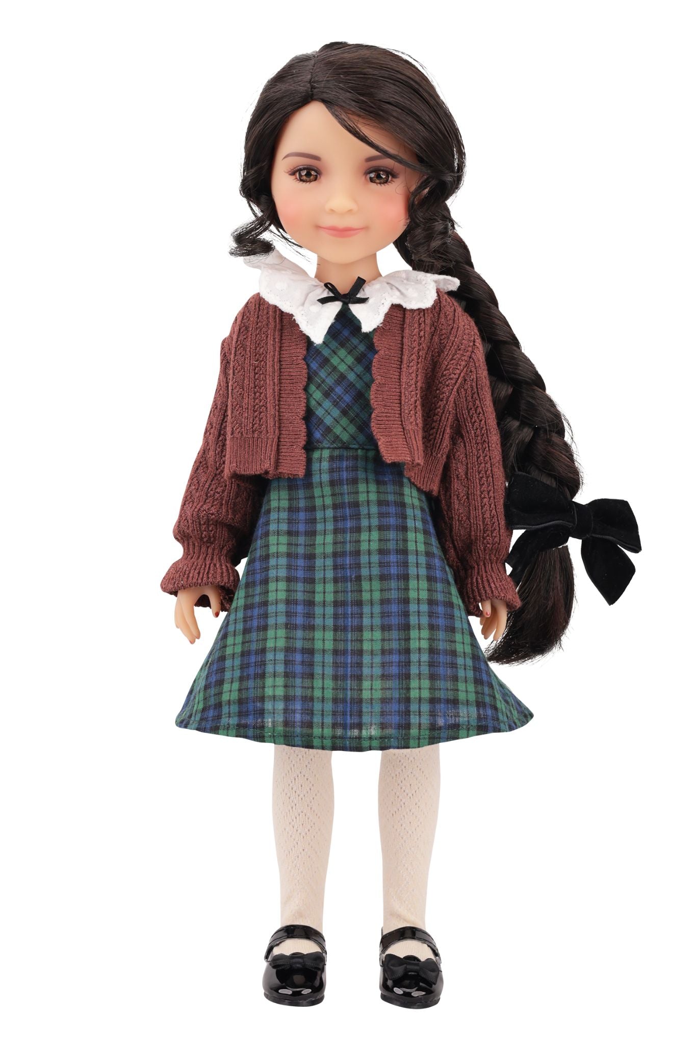 Doll wearing a plaid dress and cardigan on a white background