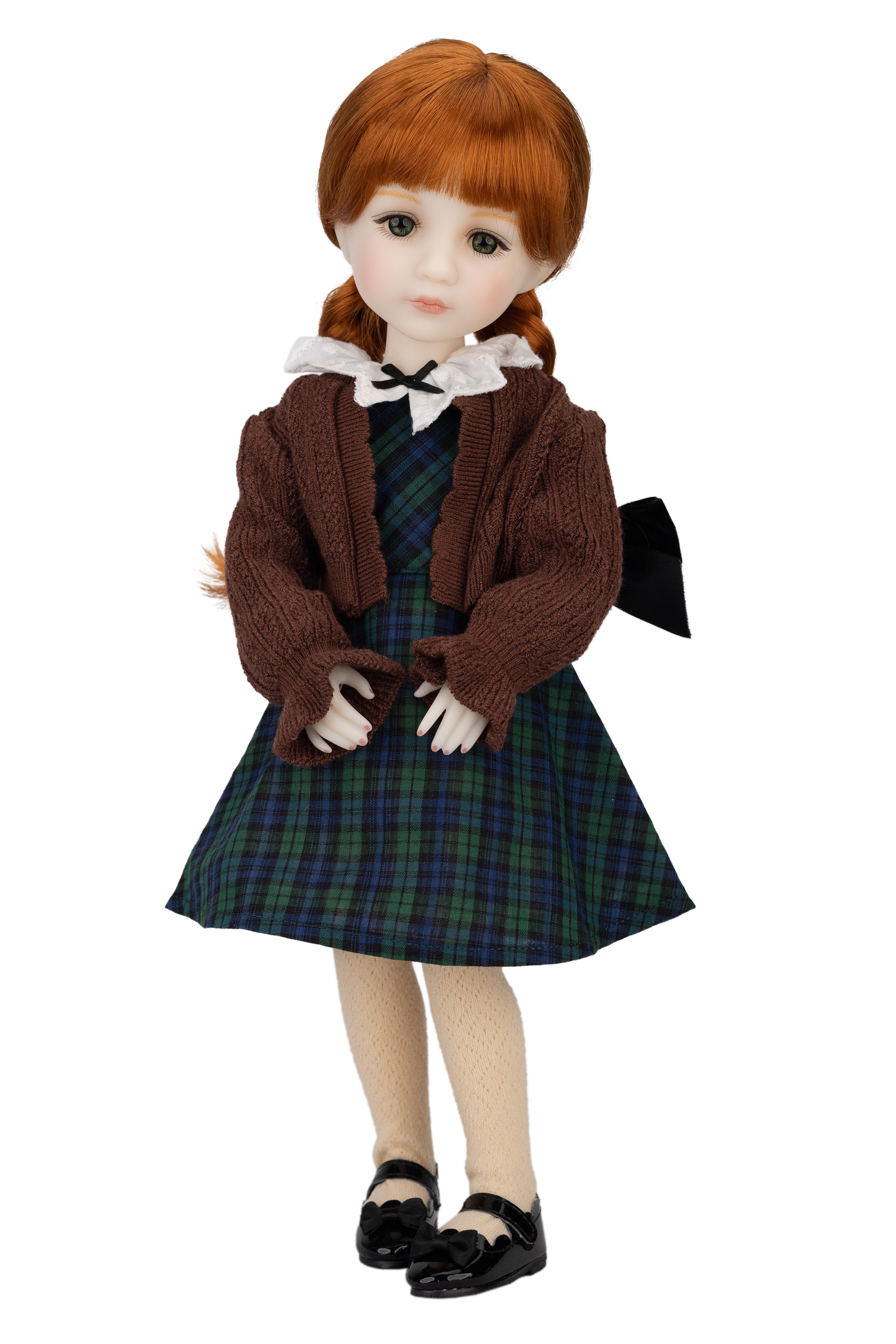 Doll with red hair wearing a brown jacket and plaid skirt on a white background