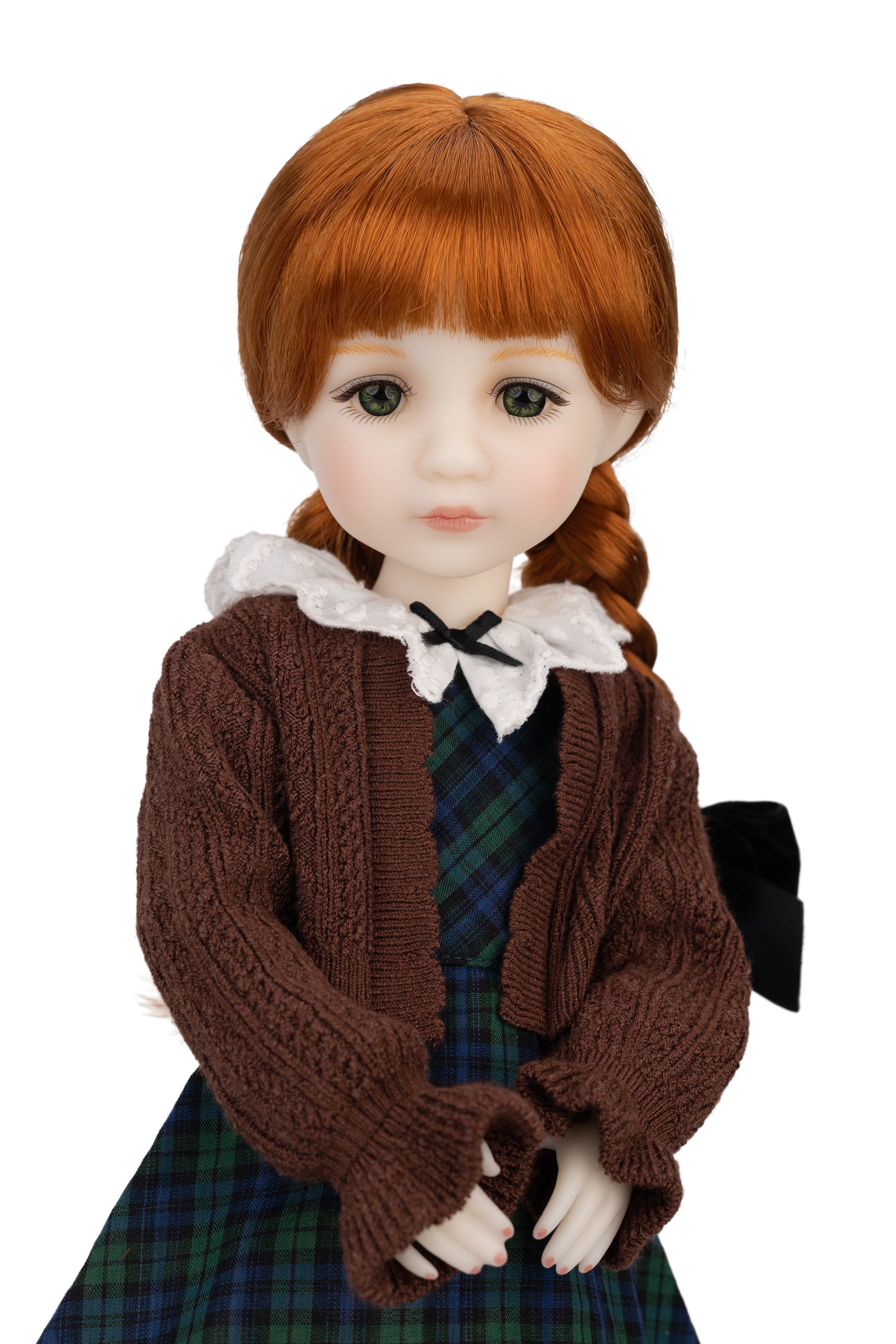 Doll with red hair styled in pigtails, wearing a brown sweater and plaid skirt on a white background