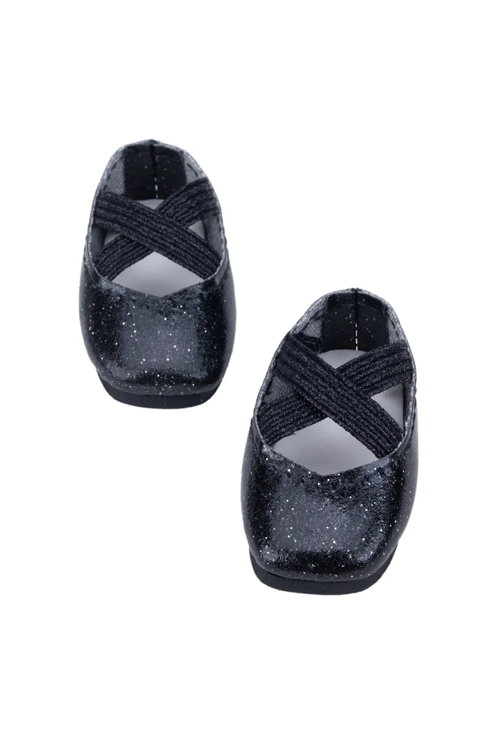 Black glittery doll shoes with criss-cross straps on a white background