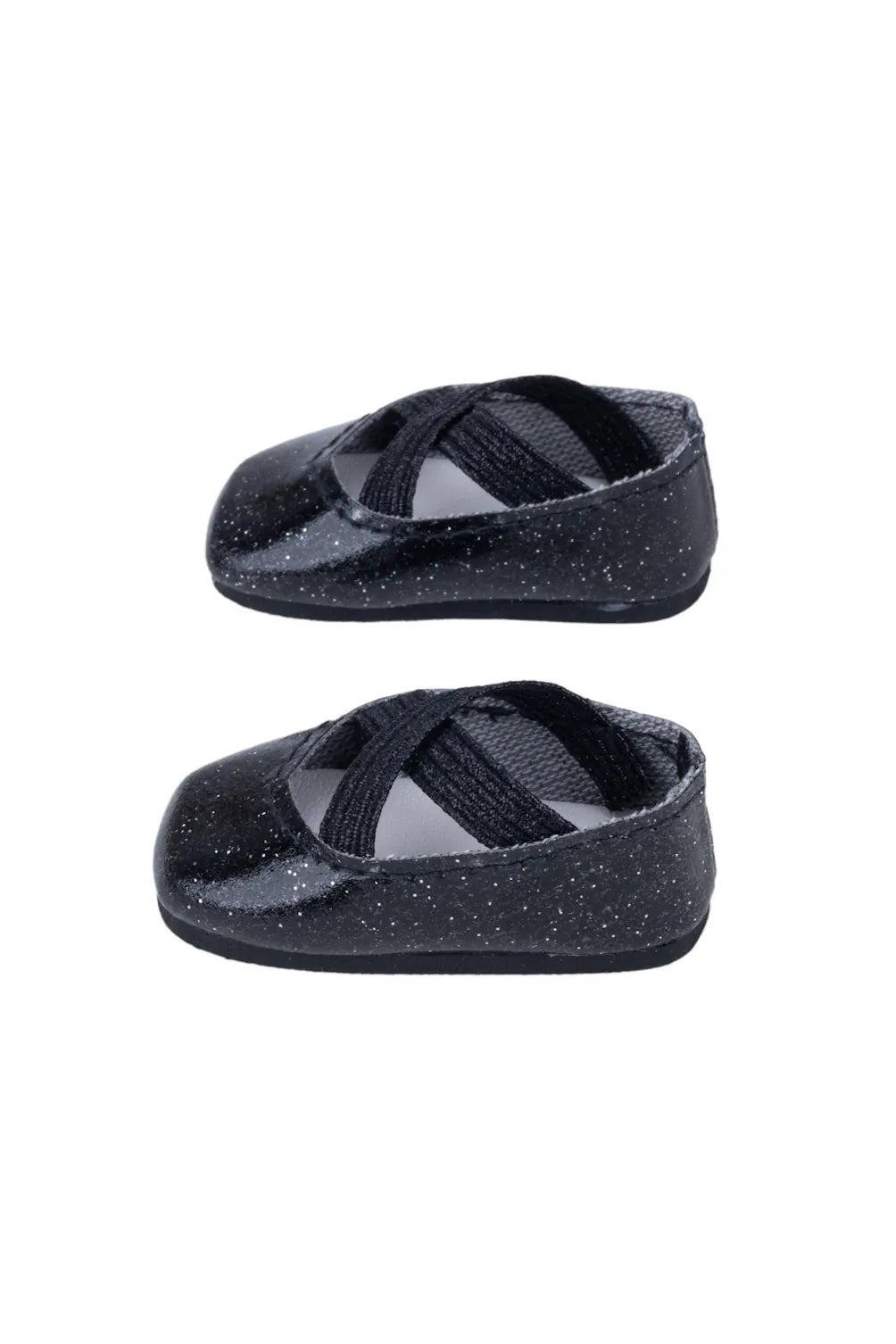 Pair of black doll shoes on a white background